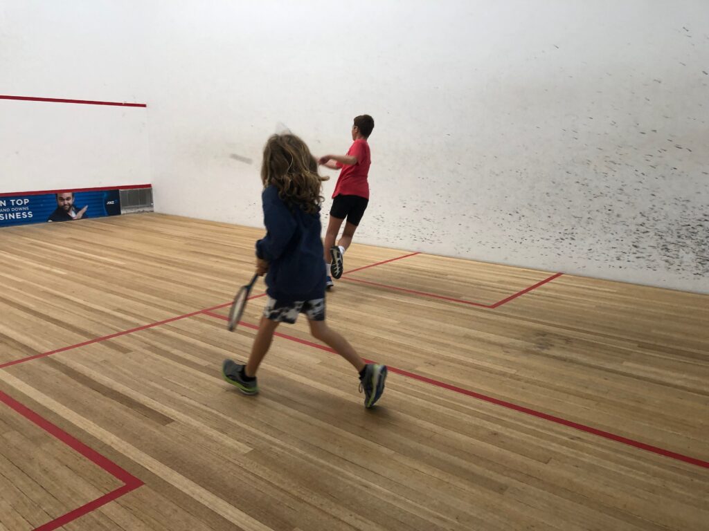 2 kids playing squash