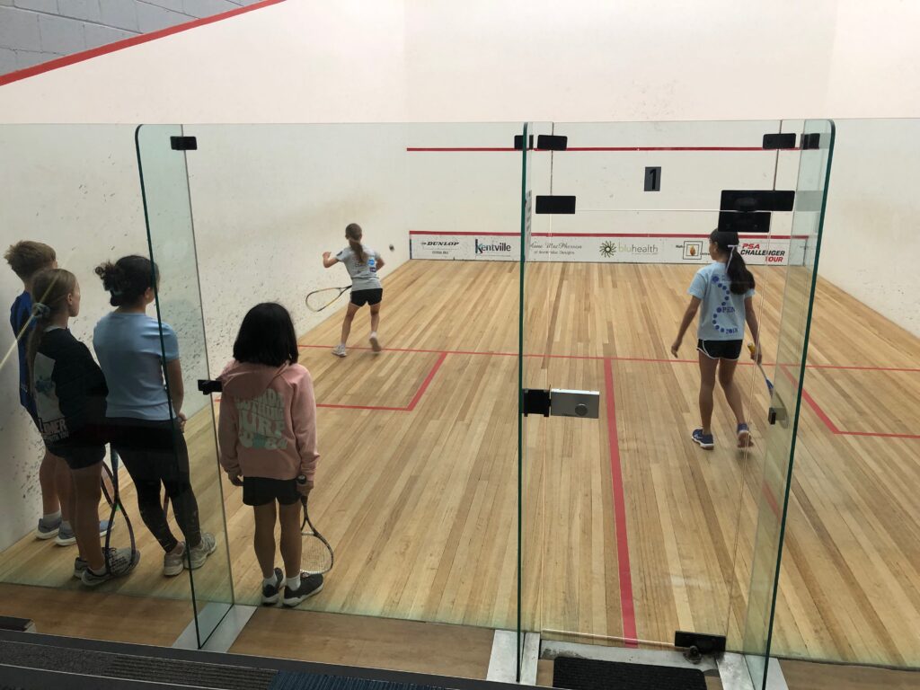 girls playing squash
